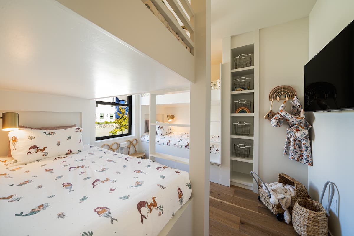 Four-bed bunk room with individual reading lights and television
