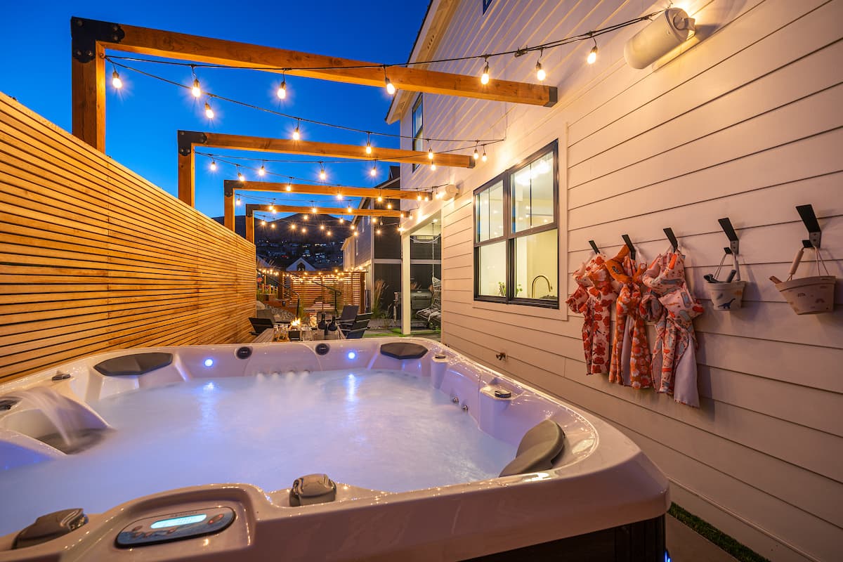 Private hot tub glowing in Coco Chelan's courtyard at night